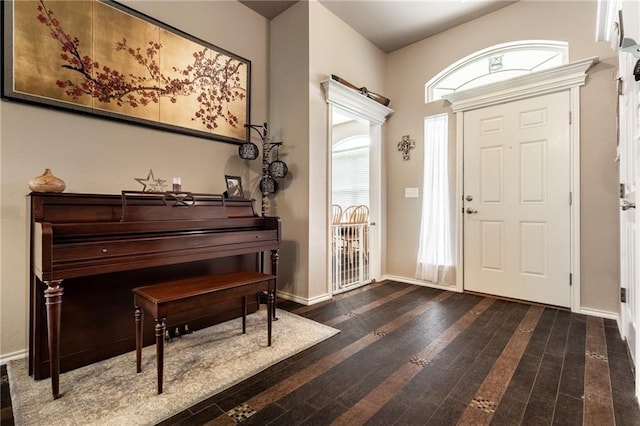 entryway featuring baseboards and hardwood / wood-style floors