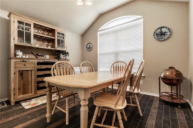 dining area with baseboards, dark wood-style flooring, and lofted ceiling