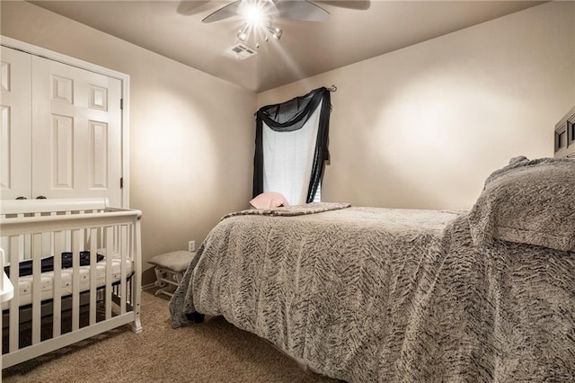 carpeted bedroom featuring ceiling fan and visible vents