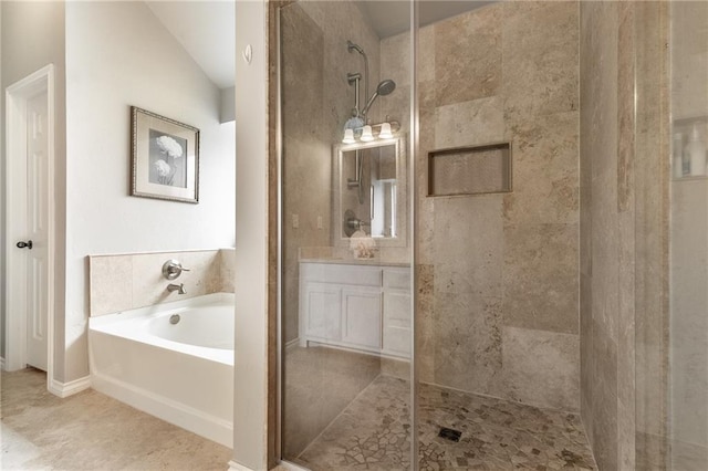 bathroom featuring tile patterned floors, a tile shower, a bath, and vanity