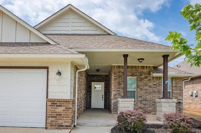 1016 NW 191st St, Edmond, OK 73012 - view of exterior entry with roof with shingles, a garage, and brick siding