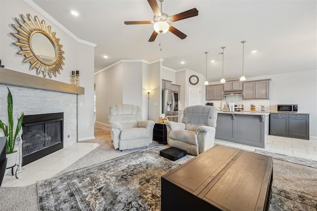 9104 SW 47th St, Oklahoma City, OK 73179 - living area with crown molding, ceiling fan, recessed lighting, a tile fireplace, and light tile patterned floors