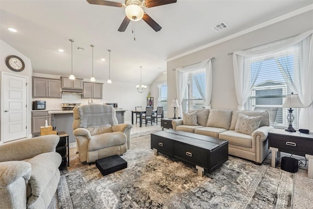 9104 SW 47th St, Oklahoma City, OK 73179 - living room with crown molding, ceiling fan with notable chandelier, lofted ceiling, and visible vents