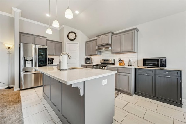 9104 SW 47th St, Oklahoma City, OK 73179 - kitchen featuring under cabinet range hood, a sink, appliances with stainless steel finishes, backsplash, and gray cabinetry