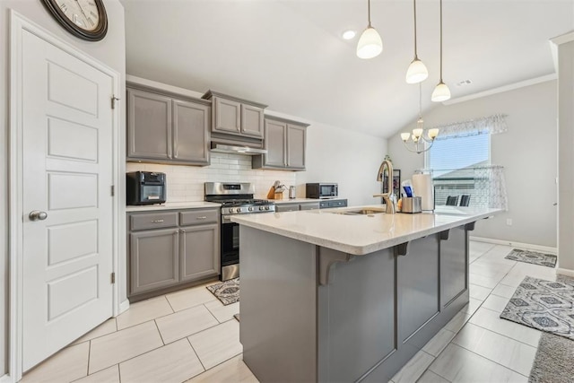 9104 SW 47th St, Oklahoma City, OK 73179 - kitchen featuring a sink, gray cabinetry, stainless steel appliances, and under cabinet range hood