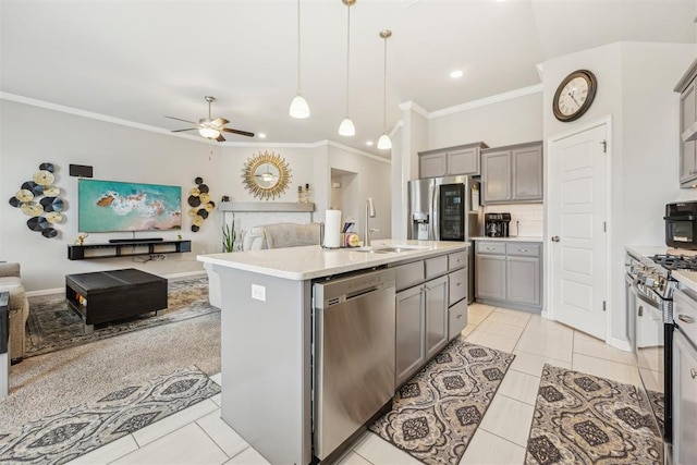 9104 SW 47th St, Oklahoma City, OK 73179 - kitchen featuring crown molding, open floor plan, gray cabinets, a sink, and appliances with stainless steel finishes