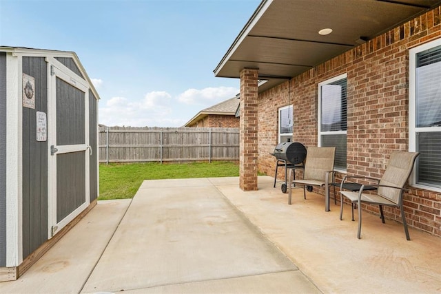 9104 SW 47th St, Oklahoma City, OK 73179 - view of patio / terrace with fence, an outbuilding, and a storage unit