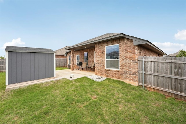 9104 SW 47th St, Oklahoma City, OK 73179 - rear view of property with an outbuilding, a patio area, brick siding, a fenced backyard, and a shed