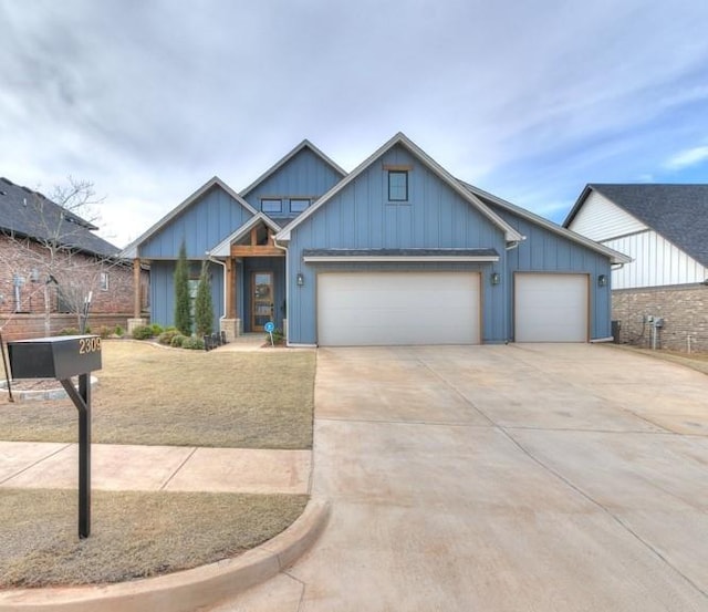view of front of house with an attached garage, board and batten siding, and driveway