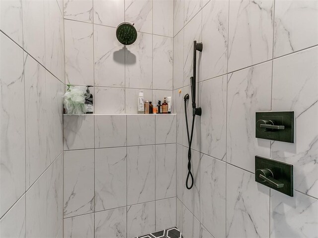 full bathroom with a tile shower