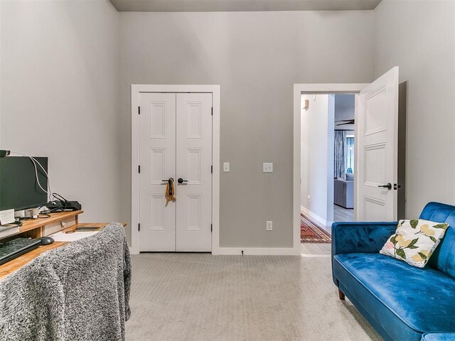 office area with baseboards and light carpet
