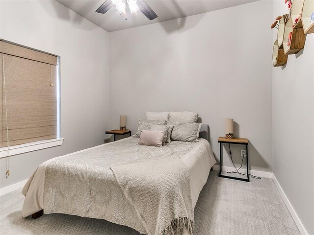 bedroom with carpet floors, a ceiling fan, and baseboards