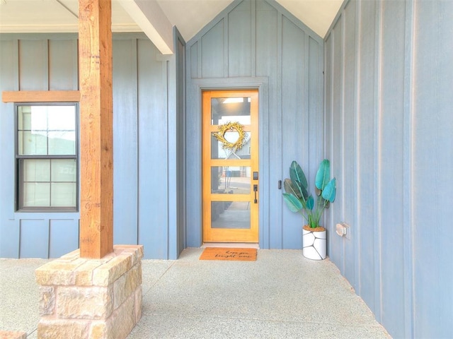 view of exterior entry featuring board and batten siding