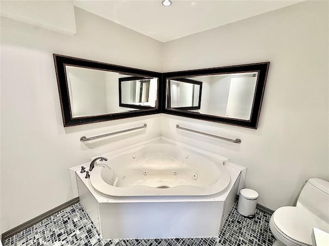 full bath featuring toilet, a jetted tub, and tile patterned flooring