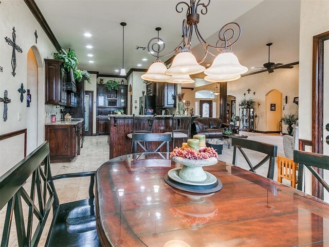 dining area with visible vents, a ceiling fan, crown molding, recessed lighting, and arched walkways