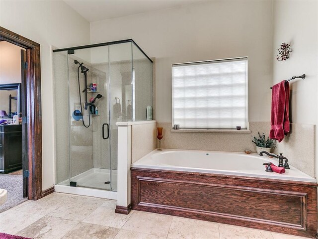 bathroom with a garden tub, tile patterned floors, and a shower stall
