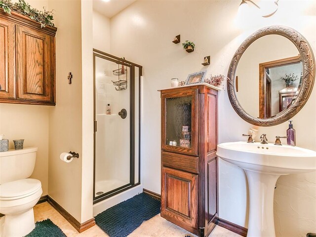 full bath featuring baseboards, tile patterned flooring, a stall shower, and toilet