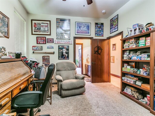 home office with carpet and a ceiling fan