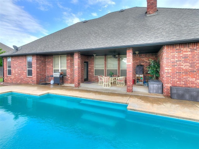 pool with a patio and a grill
