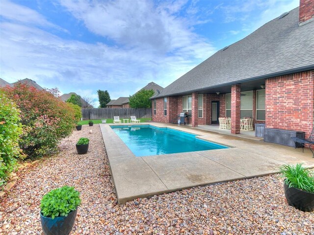 view of swimming pool featuring a patio, a fenced backyard, and a fenced in pool