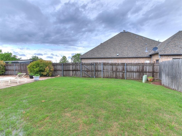 view of yard with a fenced backyard and a patio