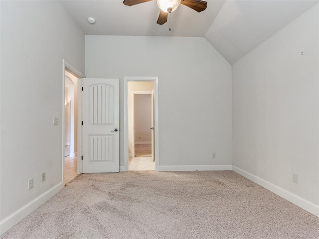unfurnished bedroom featuring baseboards, connected bathroom, a ceiling fan, carpet, and vaulted ceiling