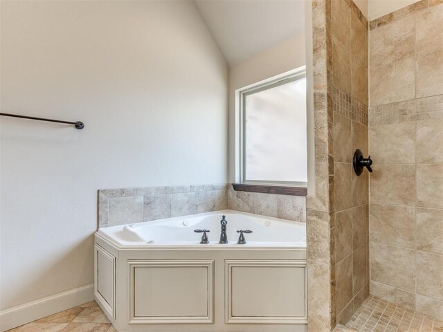 full bath featuring a garden tub, vaulted ceiling, and tiled shower