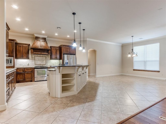 kitchen with custom range hood, arched walkways, light tile patterned floors, and stainless steel appliances