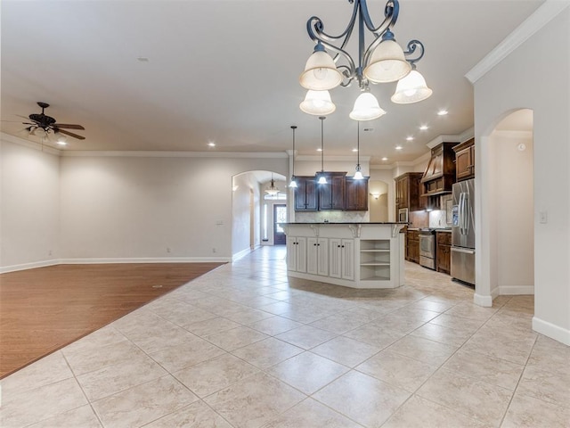kitchen featuring ceiling fan with notable chandelier, arched walkways, light tile patterned flooring, and appliances with stainless steel finishes