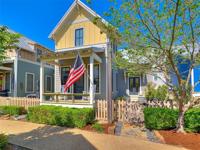 34 Boardwalk Unit B, Carlton Landing, OK 74432 - view of front of house featuring a porch, board and batten siding, and fence private yard