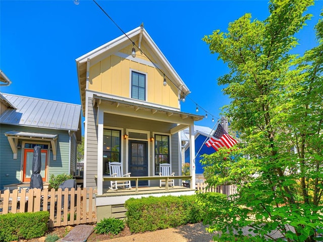 34 Boardwalk Unit B, Carlton Landing, OK 74432 - view of front of property with fence, a standing seam roof, board and batten siding, metal roof, and a porch