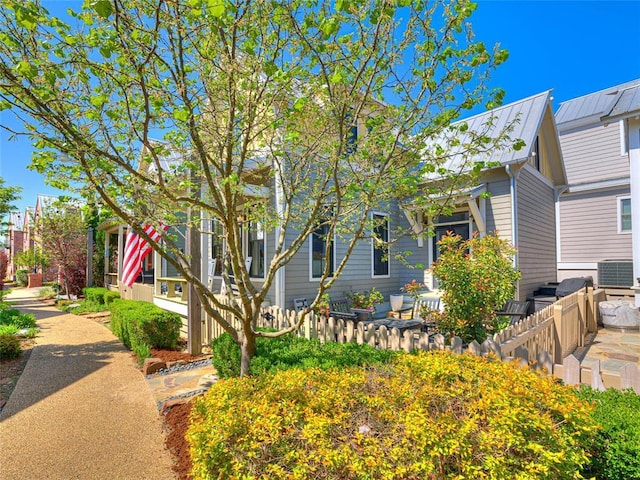 34 Boardwalk Unit B, Carlton Landing, OK 74432 - view of property hidden behind natural elements featuring fence, metal roof, a standing seam roof, and cooling unit