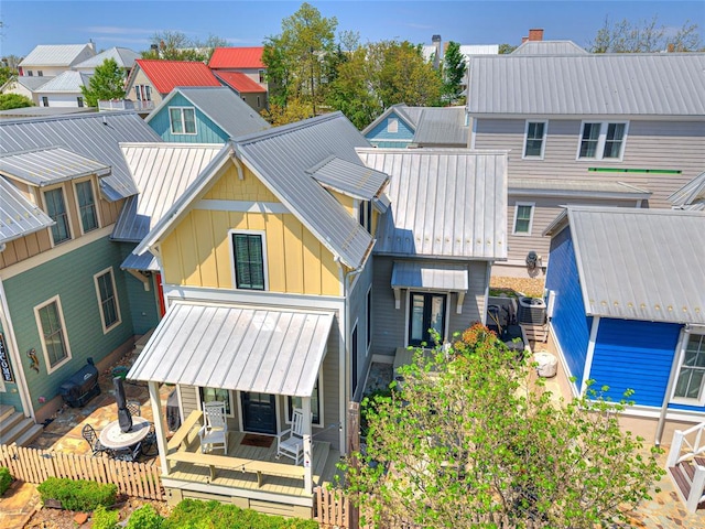 34 Boardwalk Unit B, Carlton Landing, OK 74432 - back of house featuring board and batten siding, central AC, a residential view, and metal roof