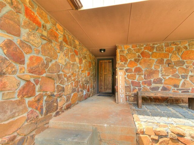 11817 Hollyrock Dr, Yukon, OK 73099 - doorway to property featuring stone siding