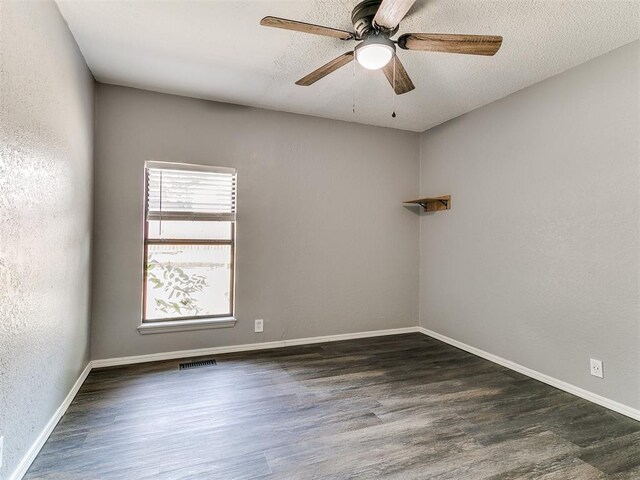 11817 Hollyrock Dr, Yukon, OK 73099 - spare room featuring dark wood finished floors, a ceiling fan, and baseboards