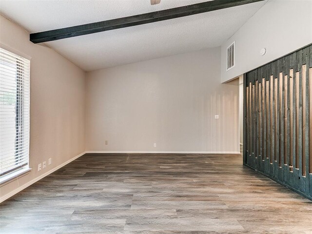 11817 Hollyrock Dr, Yukon, OK 73099 - unfurnished room featuring wood finished floors, beam ceiling, and baseboards