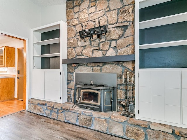 11817 Hollyrock Dr, Yukon, OK 73099 - detailed view of wood finished floors, a wood stove, and built in shelves