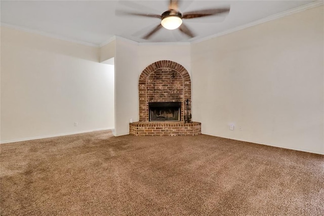 8713 Starling Path, Edmond, OK 73034 - unfurnished living room featuring carpet, ceiling fan, a brick fireplace, and ornamental molding
