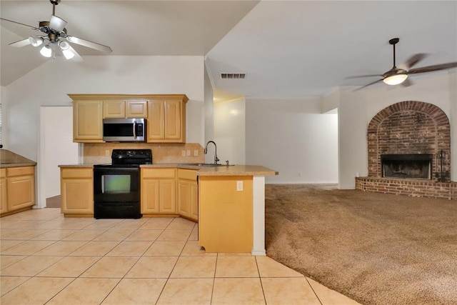 8713 Starling Path, Edmond, OK 73034 - kitchen featuring stainless steel microwave, black range with electric stovetop, a ceiling fan, a sink, and light brown cabinetry