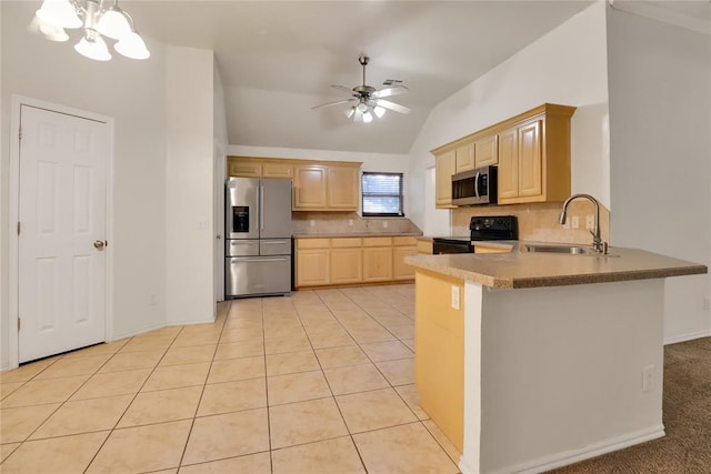 8713 Starling Path, Edmond, OK 73034 - kitchen featuring stainless steel appliances, light brown cabinets, a sink, tasteful backsplash, and vaulted ceiling