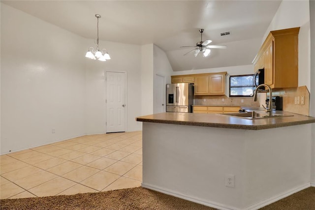 8713 Starling Path, Edmond, OK 73034 - kitchen featuring stainless steel appliances, dark countertops, a ceiling fan, a peninsula, and vaulted ceiling