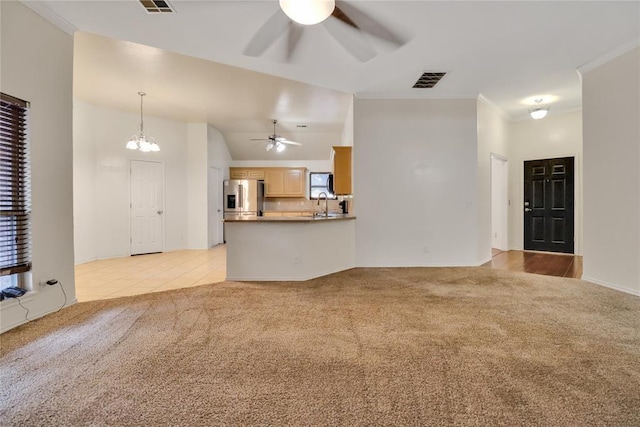 8713 Starling Path, Edmond, OK 73034 - unfurnished living room featuring a ceiling fan, light carpet, a sink, and a chandelier