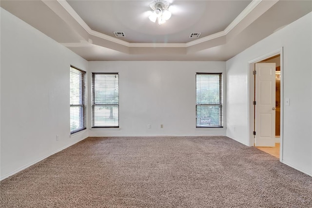 8713 Starling Path, Edmond, OK 73034 - empty room with a tray ceiling, light carpet, ceiling fan, ornamental molding, and baseboards