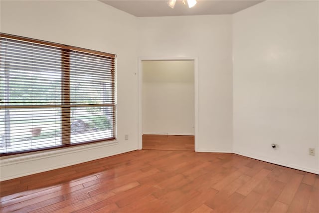 8713 Starling Path, Edmond, OK 73034 - unfurnished room featuring wood finished floors and baseboards