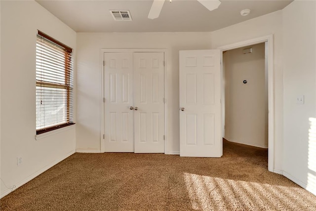 8713 Starling Path, Edmond, OK 73034 - unfurnished bedroom with carpet floors, multiple windows, and a closet