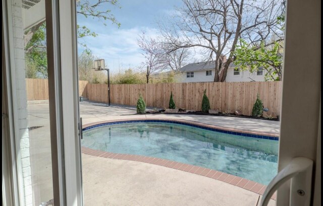 view of pool featuring a fenced in pool, a fenced backyard, and a patio area