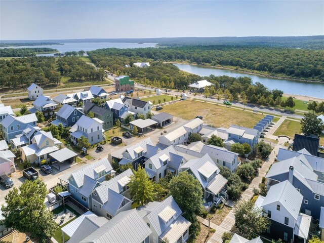 birds eye view of property with a water view, a residential view, and a wooded view