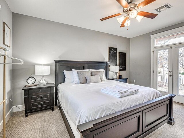 bedroom featuring ceiling fan, visible vents, baseboards, access to outside, and light carpet