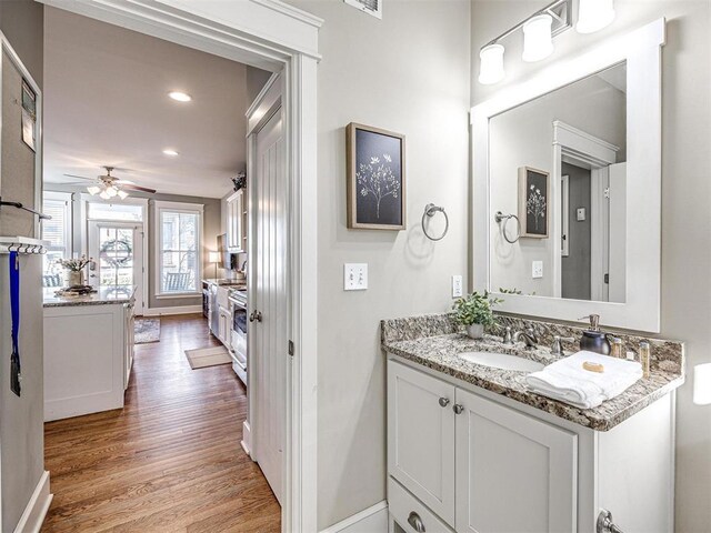 bathroom featuring baseboards, ceiling fan, recessed lighting, and wood finished floors