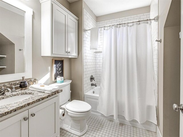 bathroom featuring vanity, tile patterned flooring, toilet, and shower / bath combination with curtain